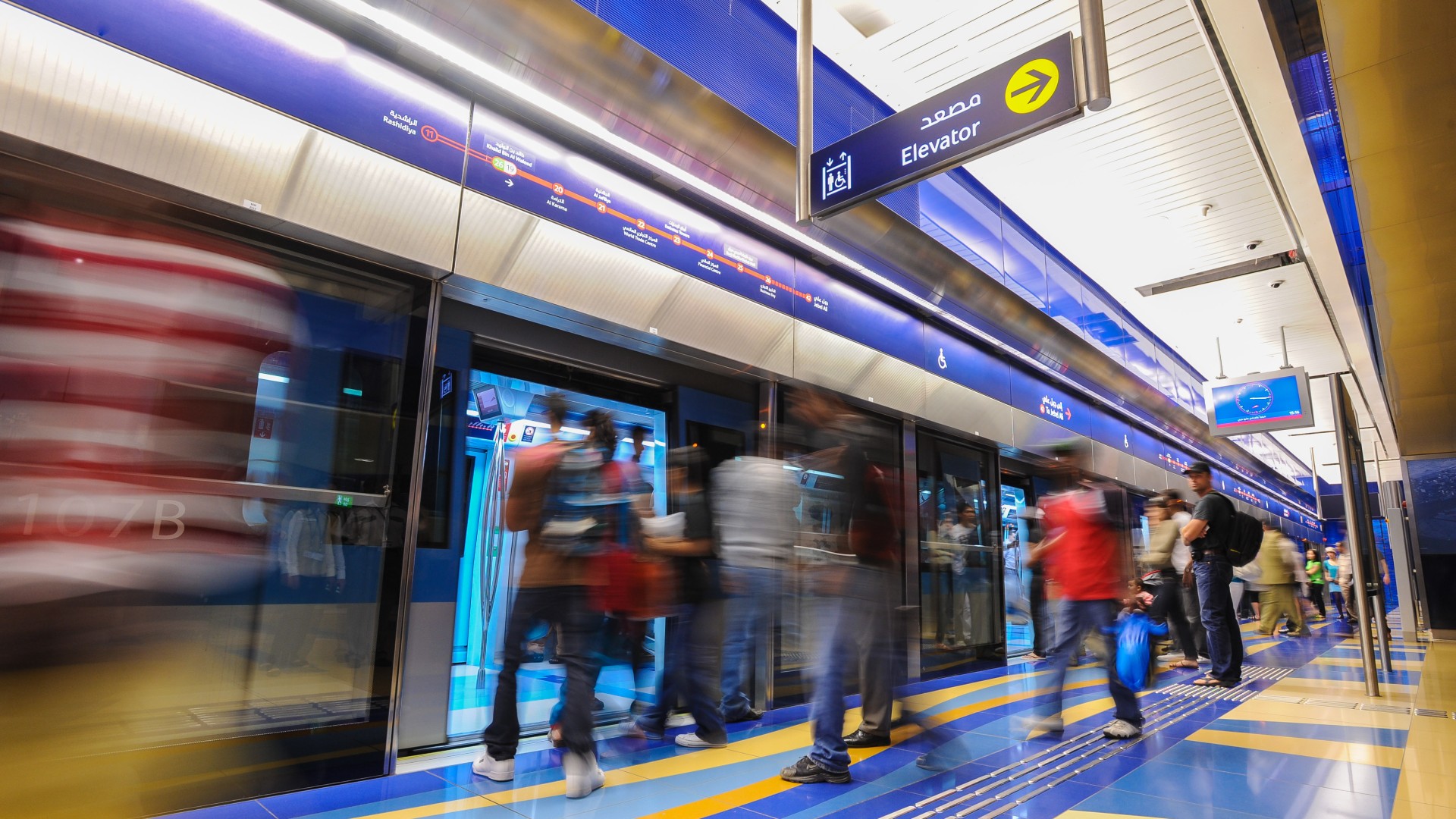 Busy metro station platform with passengers boarding